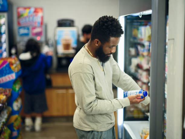 istock Young Man Buying Drinks in a Convenience Store 1996150427