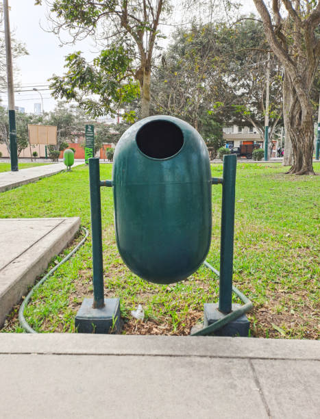 istock Green trash can, located in a beautiful park 1996150940