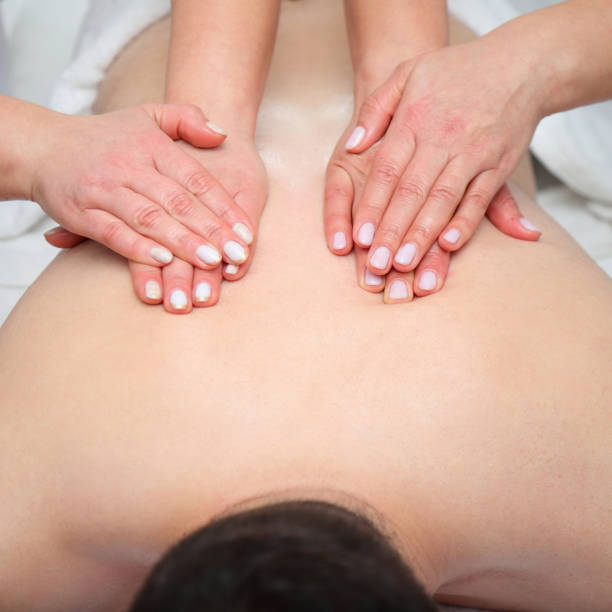 istock Four hands massage of man back, spa salon treatment 1996152472