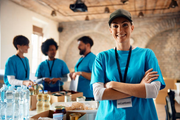 istock Confident female volunteer working at community center and looking at camera. 1996176574