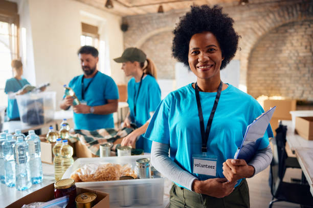 istock Happy black volunteer coordinator at community center looking at camera. 1996177081