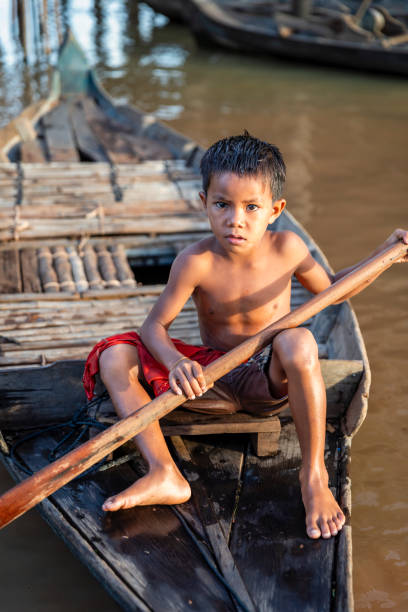 istock Cambodian boy rowing a boat, Siem Reap, Cambodia 1996179636