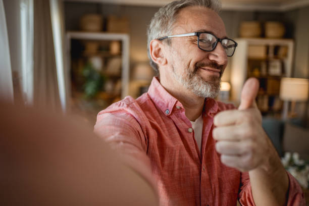istock Smiling senior man taking selfie 1996208260