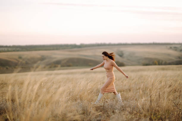 Beautiful woman in the  field. Nature, fashion, vacation, relax and lifestyle.