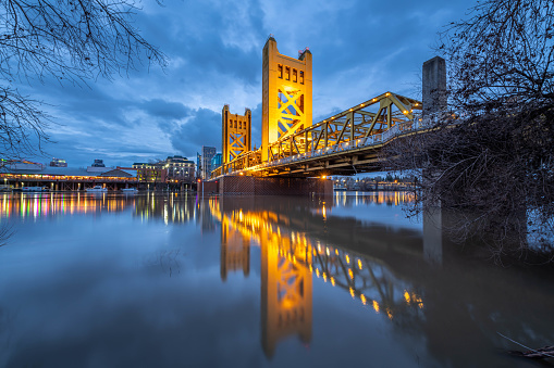 Views of Tower Bridge from along the Riverwalk in West Sacramento at twilight.