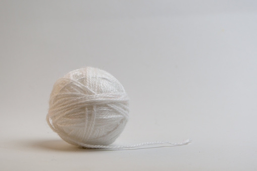 A ball of  yarn on a black background .