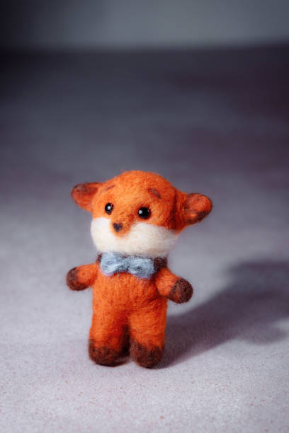 istock Soft toy red fox with a warm scarf. Hobbies to improve psychological well-being. 1996370141