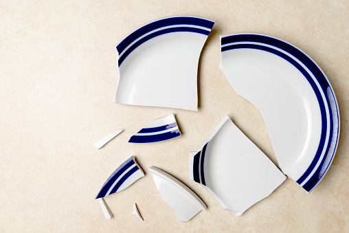 High angle view of broken plate by accident on the kitchen at home