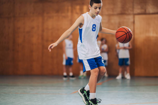 istock A junior basketball player is practicing basketball on court. 1996395612