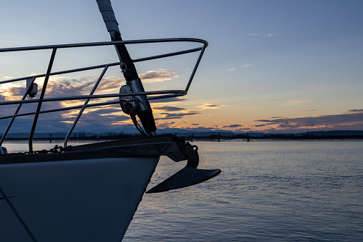 Silhouette of bow of sailboat at sunset on the Everett WA waterfront