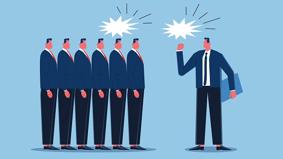 Motivating employees or team members, communicating important information, coaching or encouraging the team to achieve success, the manager standing in front of a group of businessmen waving his fist and shouting