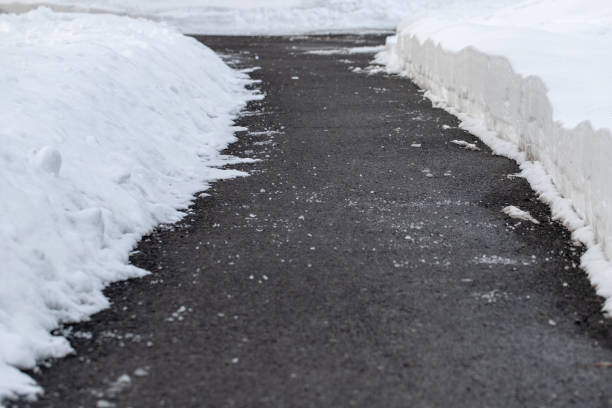 istock Road with salt for melting snow in winter. 1996442023