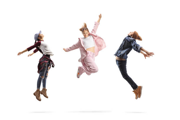 Group of young people performing dance jumps isolated on white background