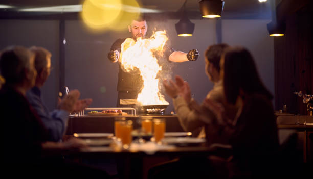 In a restaurant setting, a professional chef presents a sizzling steak cooked over an open flame, while an European Muslim family eagerly awaits their iftar meal during the holy month of Ramadan, blending culinary artistry with cultural tradition in a harmonious dining experience.