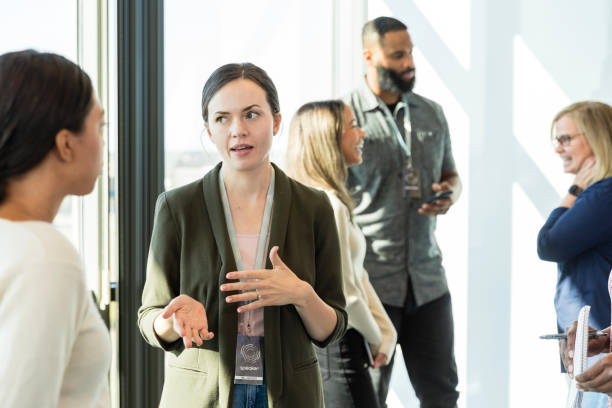 istock Business professionals break into small groups to network 1996461784