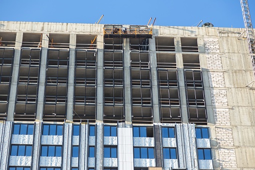 Modern Building Under Construction with Insulation Layers Exposed