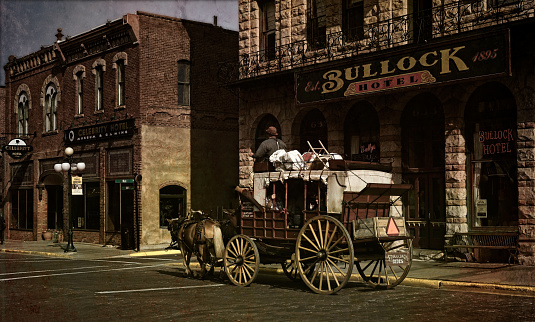 Deadwood, SD, USA - September 15: 2020. An old stagecoach provides rides for tourists in historic Deadwood. Image given an old-time, vintage look.