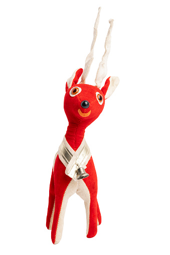 An isolated image of a midcentury felt Christmas reindeer ornament isolated on a white background.