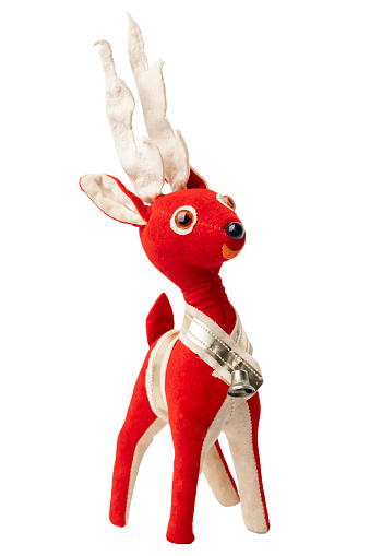 An isolated image of a midcentury felt Christmas reindeer ornament isolated on a white background.
