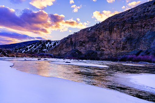 Sunset View and Reflections in River - Colorado River at sunset in scenic canyon during winter.