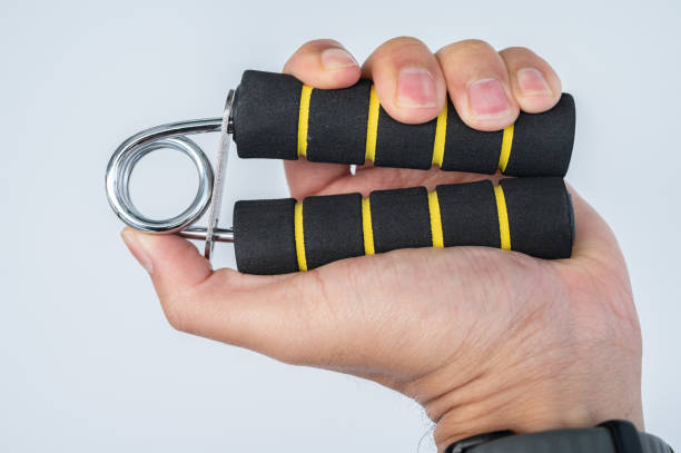 istock Cropped shot view of men's hand handle a hand grip for exercise against white background. 1996600527