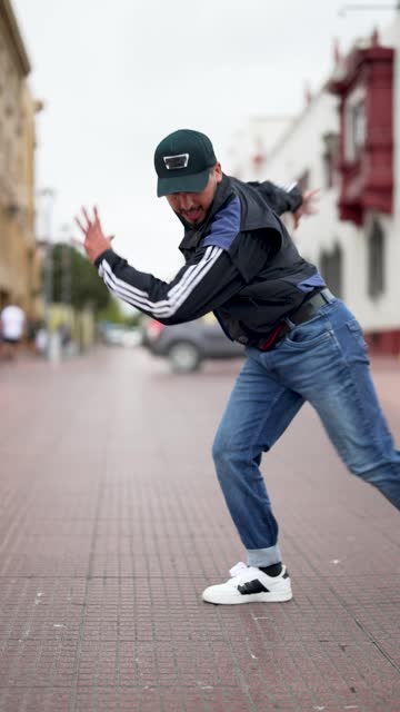 latin American breakdancer performing foot movements or toprock on the street