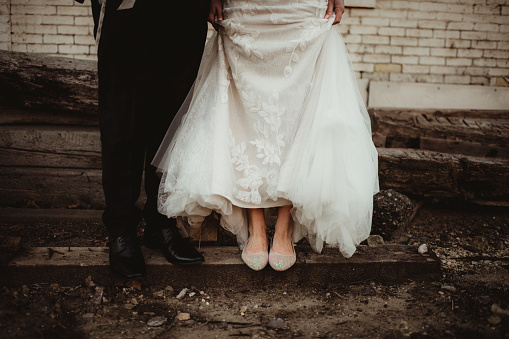 Bride and groom with shoes showing
