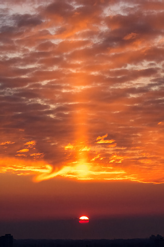 Sun Pillar, a form of natural light pillar in Meteorological term, is caused by reflective ice crystals in the earth's atmosphere. It appears with rising or setting sun