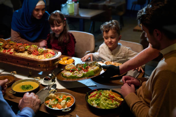 istock In this captivating aerial view, delicious food adorned with Ramadan decorations, including dates and meat, awaits the arrival of an European Islamic family, promising a festive and flavorful iftar celebration 1996719696