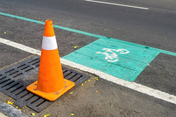 traffic cone next to the road markings for a special lane for cyclists