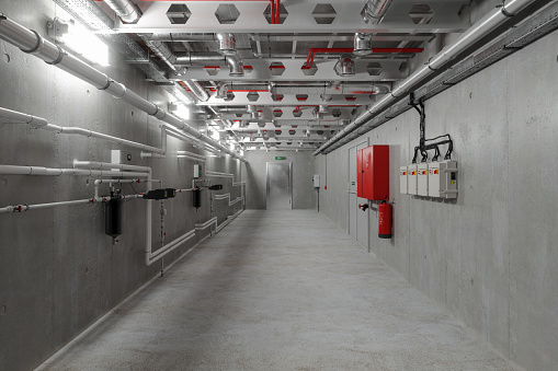 Empty Corridor With Electric Power Cables And Pipes