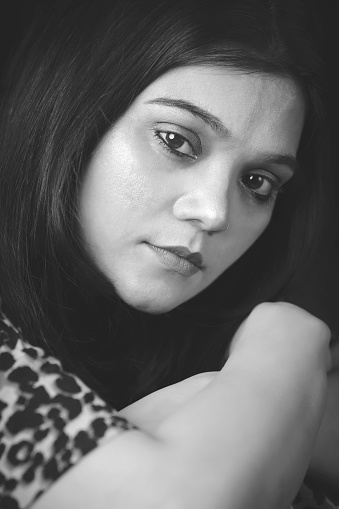 Black and white closeup portrait of a beautiful young woman