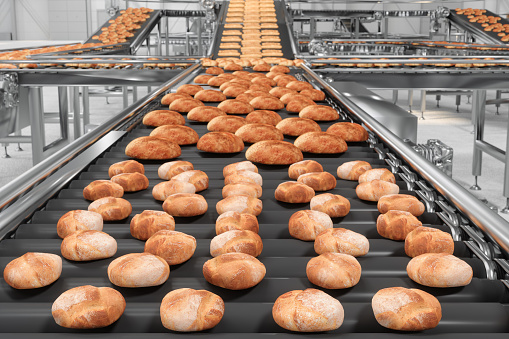 Bread Factory With Front View Of Baked Breads On Conveyor Belt