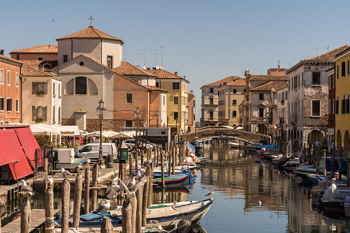 Chioggia, Italy - July 10th, 2022: View over the old town along one of the canal of the pleasant medieval city of Chioggia.