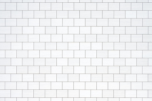 Background from a wall with rectangular white stone slabs