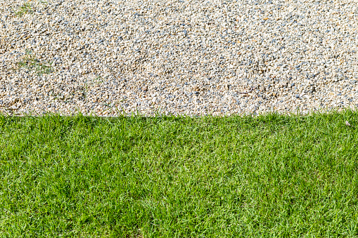 Stone walking path and fresh green grass background, outdoor day light, garden design