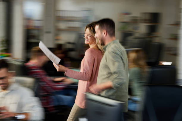 istock Happy creative colleagues reading reports on the move in the office. 1996943424