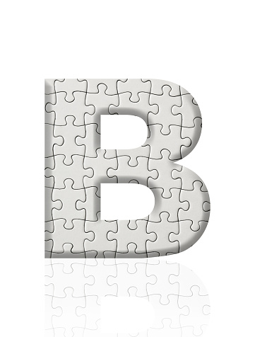 Close-up of three-dimensional blank jigsaw puzzle alphabet letter B on white background.