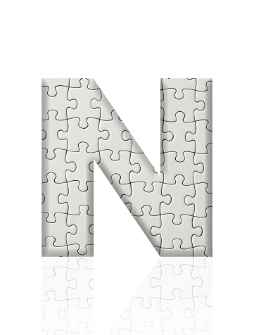 Close-up of three-dimensional blank jigsaw puzzle alphabet letter N on white background.