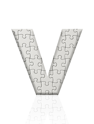 Close-up of three-dimensional blank jigsaw puzzle alphabet letter V on white background.
