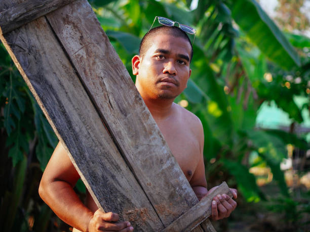 istock shirtless man carry wooden board 1996971836