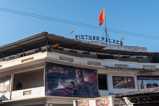 Hassan, Karnataka, India - January 10 2023: The Picture Palace cinema exhibits the latest film banners under a clear sky, showcasing Indias vibrant movie culture.
