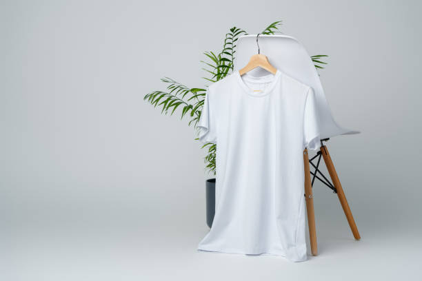 istock Blank white T-shirt hanging on a chair on white background 1996996582