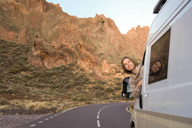 istock Young man Leaning Out Van Window on Side of Road 1997024794