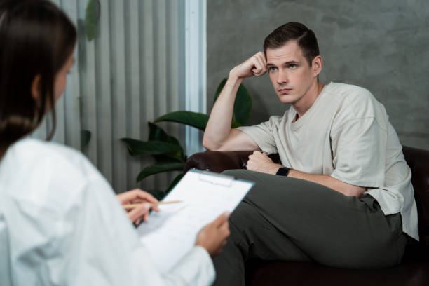 istock Stressed and depressed patient seeking help from psychiatrist. Unveiling 1997046328