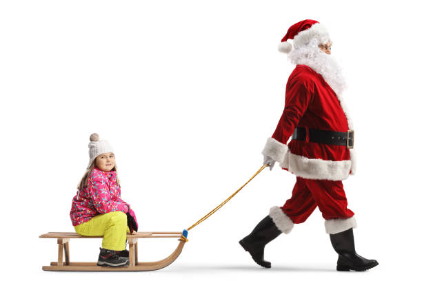 istock Santa clus pulling a little girl on a wooden sled 1997048960