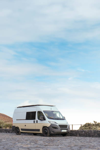 istock White Van Parked on a Cobblestone Road Surrounded by a Natural Landscape 1997050013