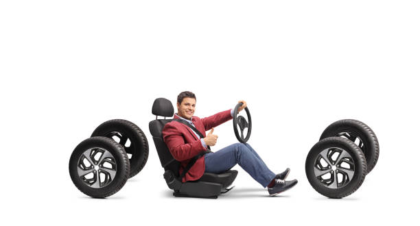 istock Man holding a steering wheel and gesturing thumbs up 1997051593