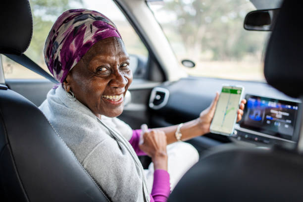 istock Smiling senior women using a mobile map app during a road trip 1997059565