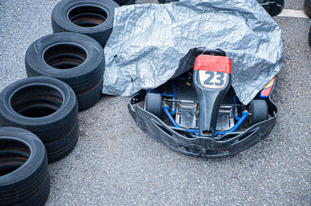 go kart racing car It was covered with a raincoat and parked awaiting repairs so it could race again.
